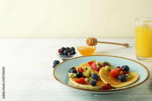 Concept of delicious dessert with pancakes on white wooden table