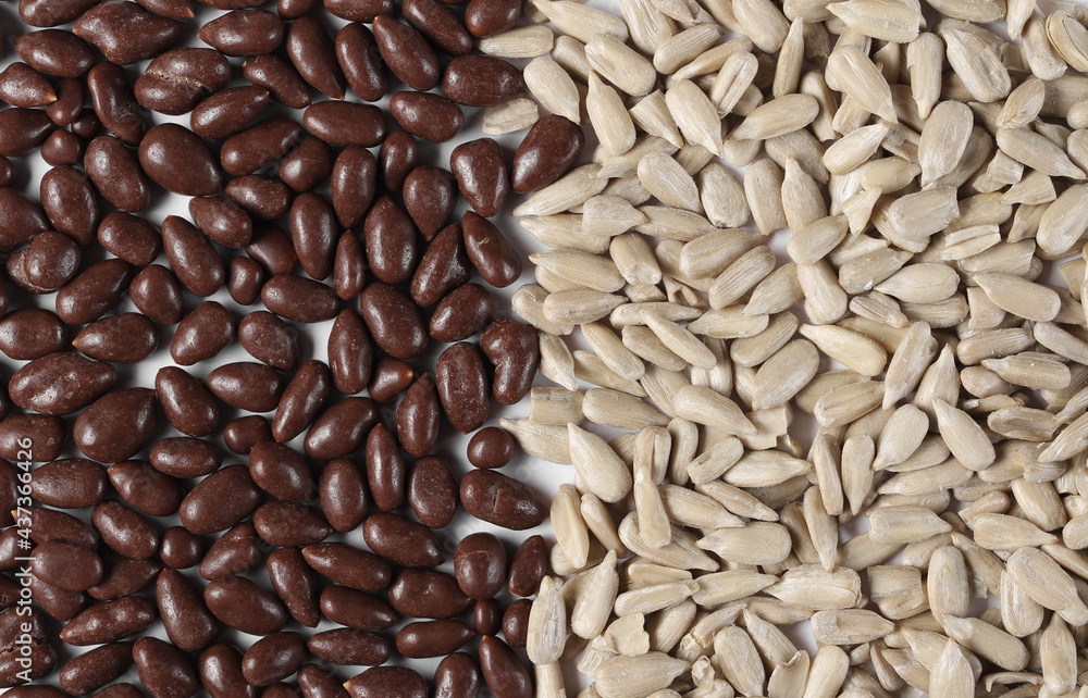 Chocolate covered and unshelled sunflower seeds isolated on white background, top view Chocolate covered and unshelled sunflower seeds isolated on white background, top view