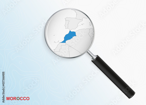 Magnifier with map of Morocco on abstract topographic background.