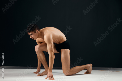 athletic man muscled body black panties studio kneeling
