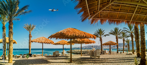 Fototapeta Naklejka Na Ścianę i Meble -  Panorama. Morning on sandy beach in Eilat - famous tourist resort and recreation city in Israel
