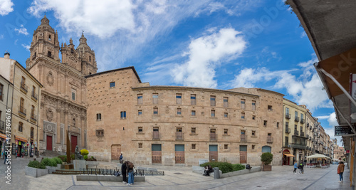 Panoramic view with Casa de las Conchas latera facade and baroque iconic facade at the La Clerecía building, Pontifical university at Salamanca