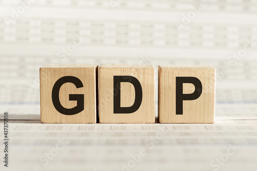 GDP abbreviation - gross domestic product, on wooden cubes on a light background. photo