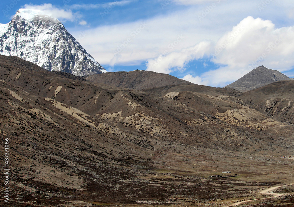 A panoramic view of snow-covered mountainous barren flat land called Tibetan Plateau near India-China border situated at 17,800 ft altitude in Sikkim, India. This is the cold desert of Sikkim. A panoramic view of snow-covered mountainous barren flat land called Tibetan Plateau near India-China border situated at 17,800 ft altitude in Sikkim, India. This is the cold desert of Sikkim.