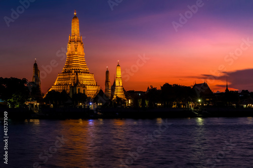 View of beautiful Wat Arun Rajvararam or Wat Arun or Wat Makok at waterfront of the Chao Phraya River in twilight Which is historical significance and famous tourist destination of Bangkok Thailand.