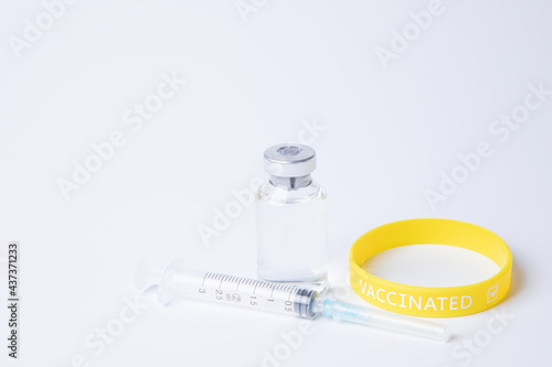 vials of medicine/vaccine, syringe and rubber wrist band with 