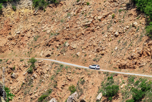 Car on dangerous mountain road in the rocks