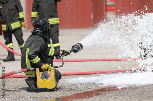 firefighters with the special flame retardant foam extinguish a fire