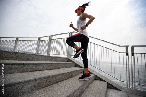 Healthy lifestyle fitness sports woman runner running on seaside trail