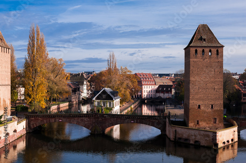 Strasbourg silhouette with panorama view of river bridges and brick towers of the island and the church La Petite France, Strasbourg, Alsace, France © Alevtina