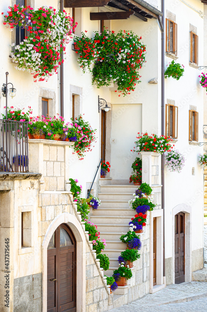 Pescocostanzo, Italy. August 24th, 2012. Facades of historic buildings decorated with plants and flower pots of different colors in Strada di S. Francesco street.