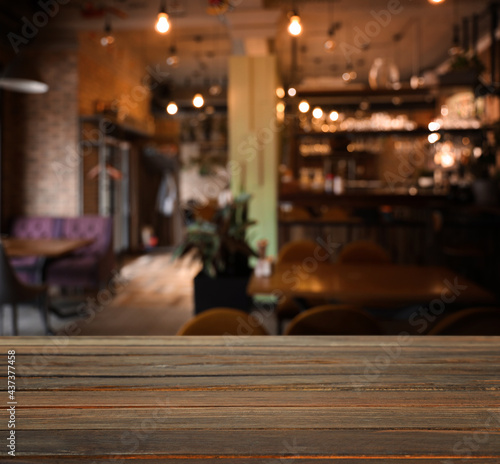 Empty wooden table in cafe. Bokeh effect