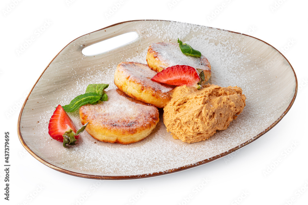 Cottage cheese pancakes with strawberry and sugar powder isolated