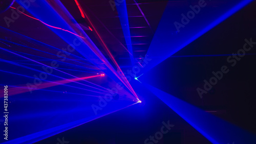 Blurry background with laser blue lights of a disco, dance floor