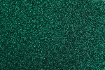 Shiny dark green glitter as background, closeup