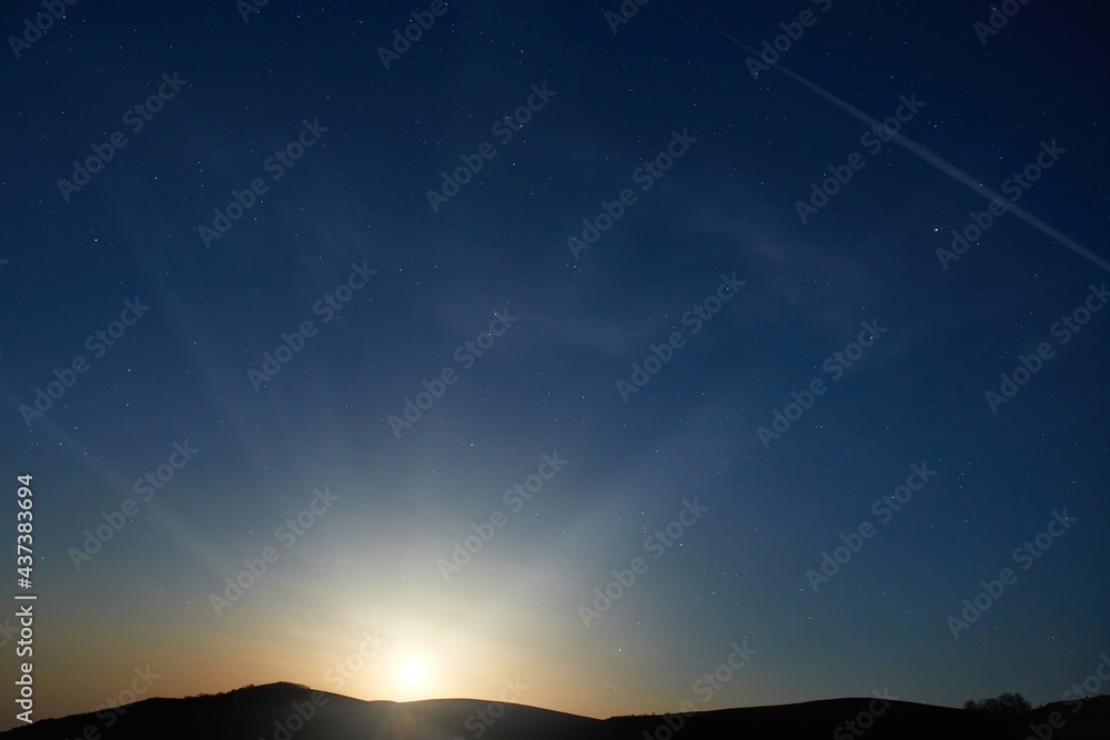 Fototapeta premium Mountains with night sunset sky with many stars, full moon rising. Night sky background