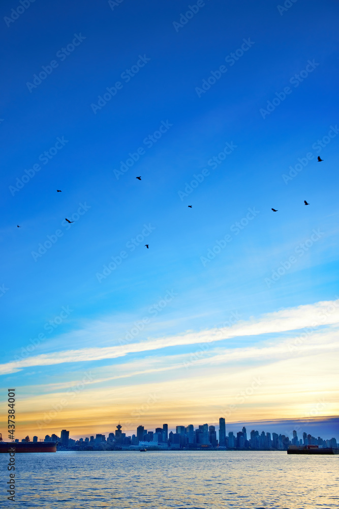 Night city, panoramic scene of downtown reflected in water. Sunset above Vancouver, Canada Night city, panoramic scene of downtown reflected in water. Sunset above Vancouver, Canada