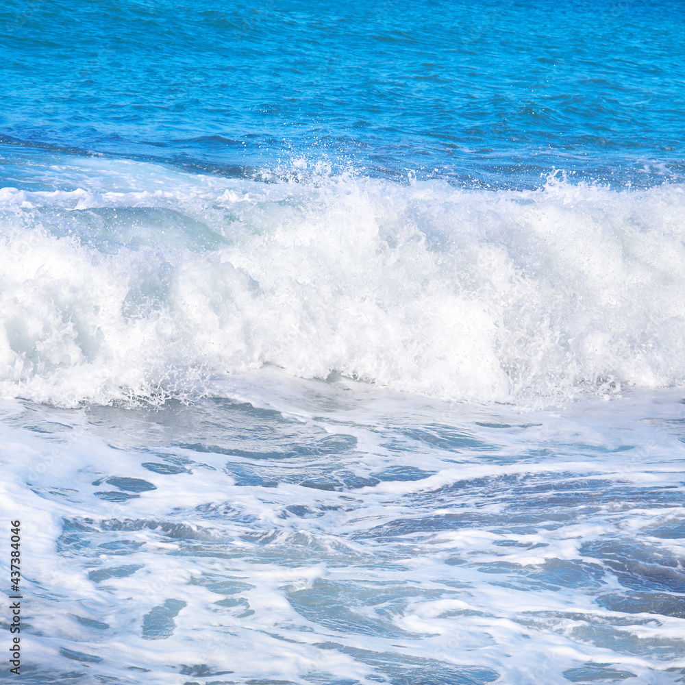 Big wave with sea foam and blue water