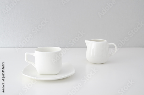 Set of white utensils for coffee on a white background