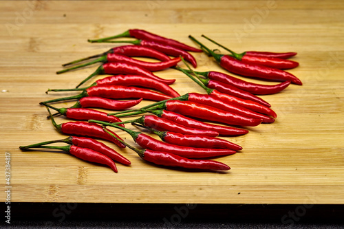 red chili peppers on wooden table 