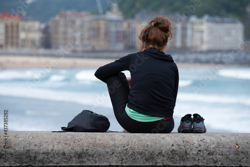 lonely person looking at the sea
