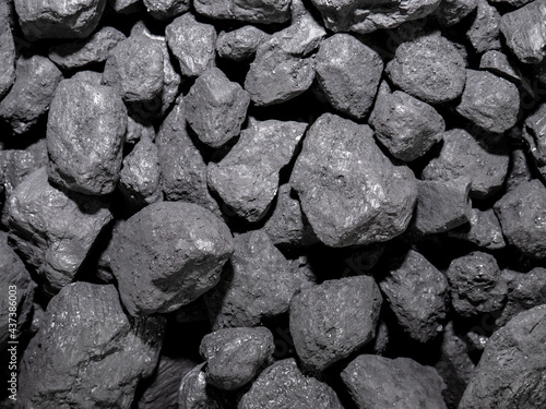 A pile of carbon stones piled up for later combustion, forming an energetic background of this precious mineral used in homes for combustion and producing heat energy to heat the home photo