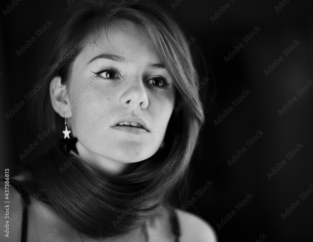 A beautiful young woman with red curly long hair posing at studio. Beauty woman monochrome portrate. Black-white art photography. A beautiful young woman with red curly long hair posing at studio. Beauty woman monochrome portrate. Black-white art photography.