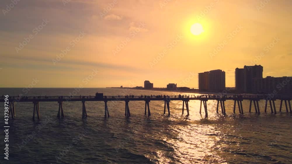 A stunning drone shot of the longest pier in Florida at sunset with golden colors A stunning drone shot of the longest pier in Florida at sunset with golden colors