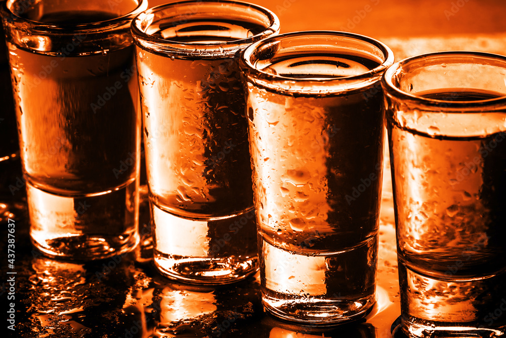 Glass vodka shots. Alcohol drinks in a row texture. Weekend party