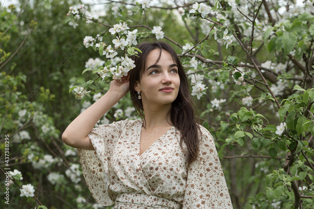Portrait of a positive cheerful brunette girl in a green spring park Portrait of a positive cheerful brunette girl in a green spring park