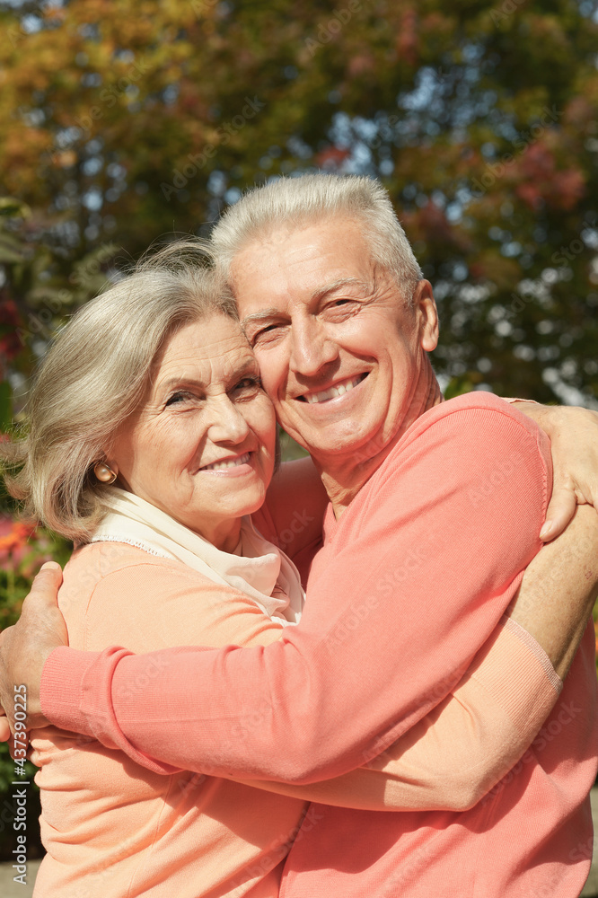 smiling senior couple embracing in autumn park smiling senior couple embracing in autumn park