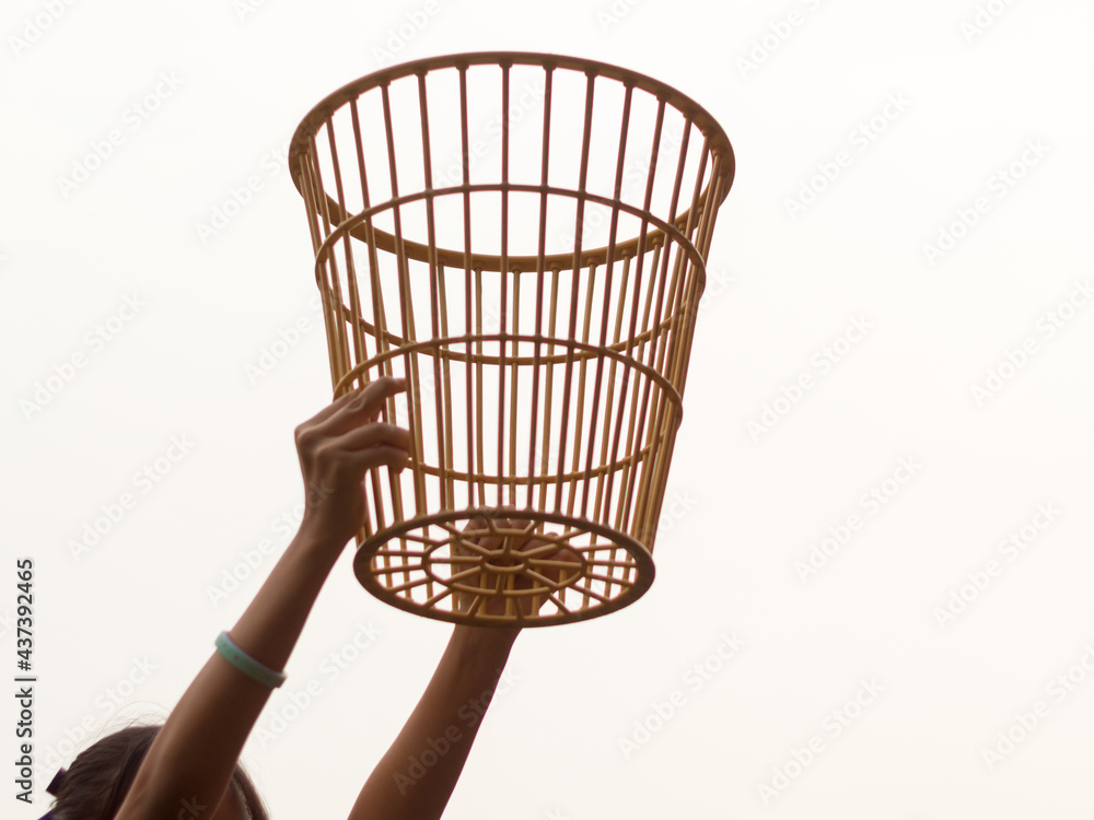 A girl in a basket holding position in a school chair-ball game A girl in a basket holding position in a school chair-ball game
