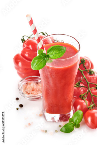 Glass of fresh tomato juice, basil and tomatoes isolated on white background. With copy space