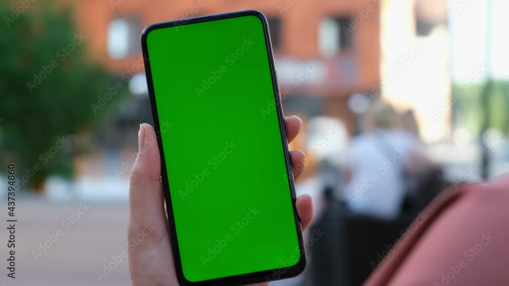 Handheld Camera: Point of View of Woman at street Using Phone With Green Mock-up Screen Chroma Key Surfing Internet Watching Content Videos Blogs Tapping on Center Screen Handheld Camera: Point of View of Woman at street Using Phone With Green Mock-up Screen Chroma Key Surfing Internet Watching Content Videos Blogs Tapping on Center Screen