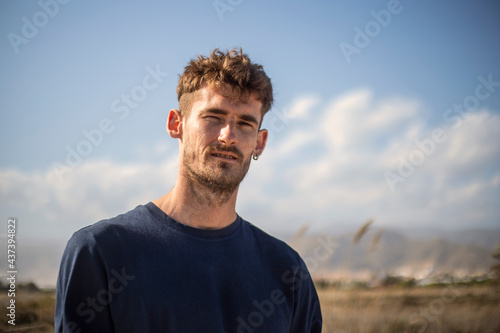 Photography of one young caucasian blonde man portrait outdoor
