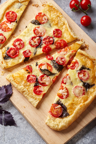 Puff pastry tart with cherry tomatoes, mozzarella and purple basil