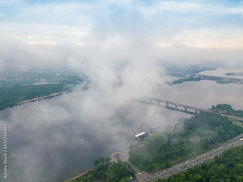 High view of the Dnieper River in Kiev through the clouds. Spring cloudy morning. Aerial high view.