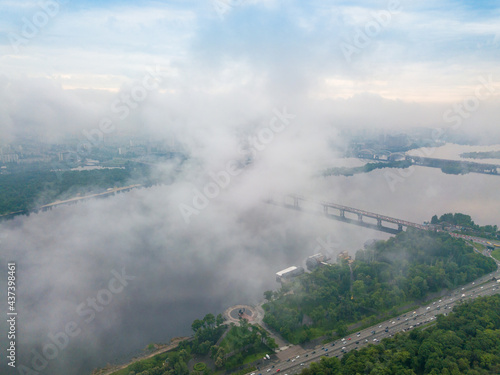 High view of the Dnieper River in Kiev through the clouds. Spring cloudy morning. Aerial high view.