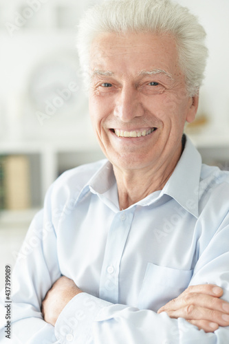 portrait of happy senior man at home