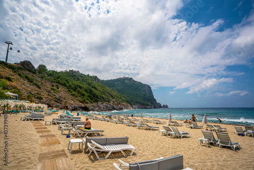 Fototapeta Naklejka Na Ścianę i Meble -  Cleopatra beach on sea coast with green rocks in Alanya 