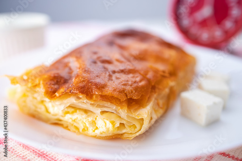 Baked cheese pie with milk. Bulgarian butter banitsa for breakfast photo