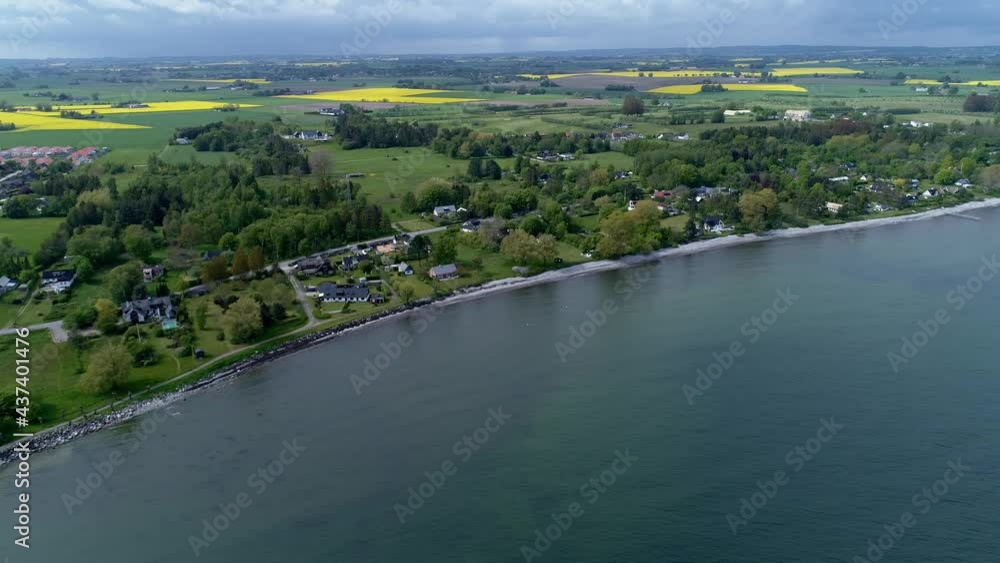 Distant View Of Rapeseed Fields With Yellow Crops From Hano Bay In Skane, Sweden. aerial Distant View Of Rapeseed Fields With Yellow Crops From Hano Bay In Skane, Sweden. aerial