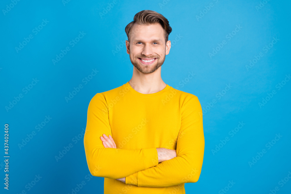 Photo portrait of man confident smiling happy with folded hands isolated on vivid blue color background Photo portrait of man confident smiling happy with folded hands isolated on vivid blue color background