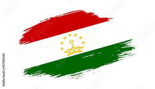 Patriotic of Tajikistan flag in brush stroke effect on white background