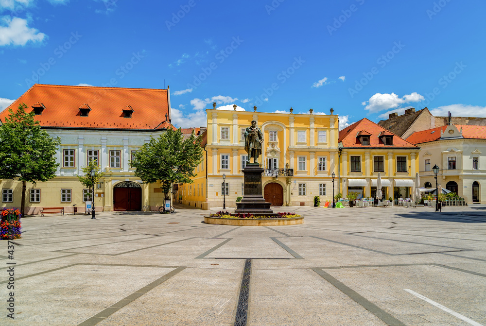 View of the Vienna's Gate Square in Gyor,in the middle the sculpture of famous Hungarian writer Karoly Kisfaludy, and around it the little cozy old buildings.