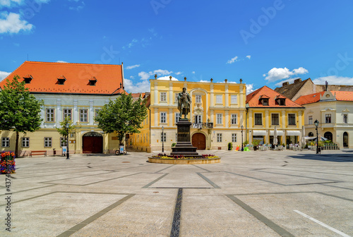 Photography View of the Vienna's Gate Square in Gyor,in the middle the sculpture of famous Hungarian writer Karoly Kisfaludy, and around it the little cozy old buildings
