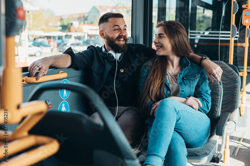 Young beautiful couple in love sitting in a bus
