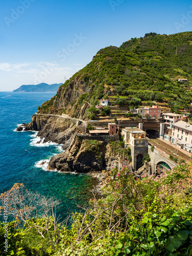 Railway station tracks in tunnel over the bay next to the cliff gulf in Cinque Terre National Park in Italy on city hill.