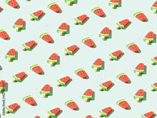 Creative pattern made with watermelon icecream. Minimal pastel green summer party background.