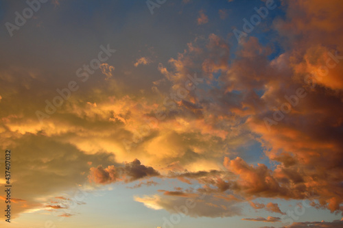 Colorful altocumulus clouds on blue sky background with sunrise. photo